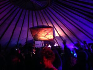 Interior of 30 ft diameter Hearthworks Yurt lit up at night