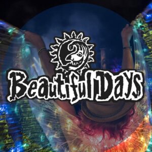 Beautiful Days Festival Logo with an image of a woman at a music performance, who is wearing a fedora and a sparkly, illuminated rainbow coloured shawl spread open like wings.