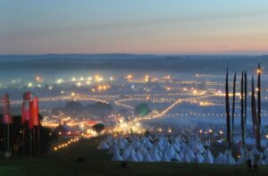 panorama of Glastonbury festival at night with the Tipi Village accommodation area