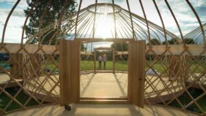 Looking through the double doors of a conjoined Hearthworks Yurt frame without the canvas cover