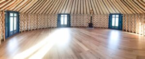 wooden floor inside a 30 ft diameter Hearthworks Yurt